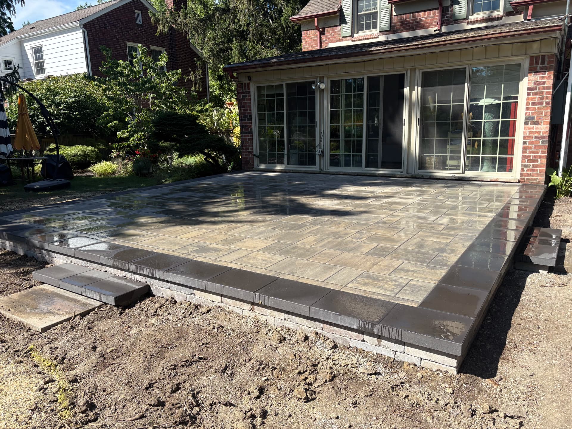 Old Deck Replaced With a Raised Unilock Beacon Hill Paver Patio image