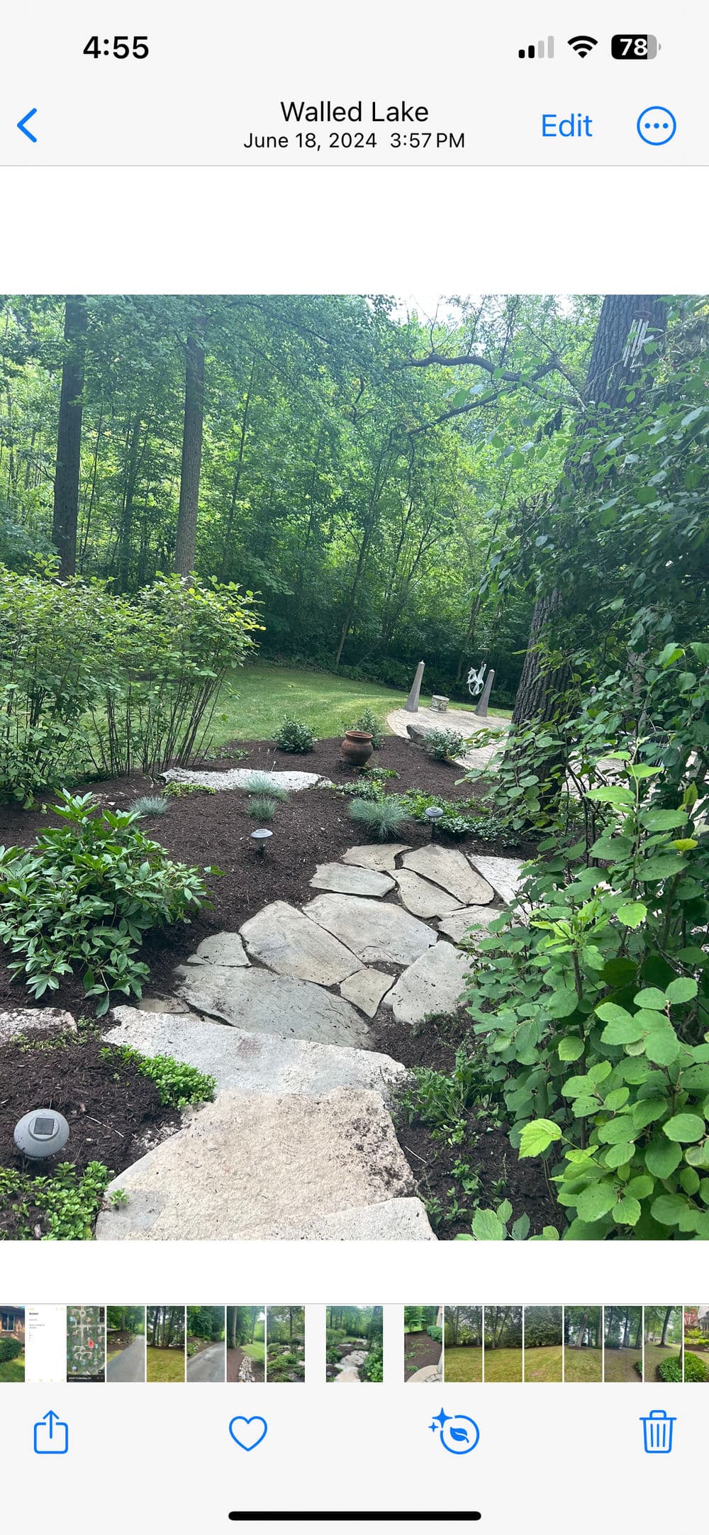 Stone pathway through lush greenery at Walled Lake, showcasing a serene outdoor setting.